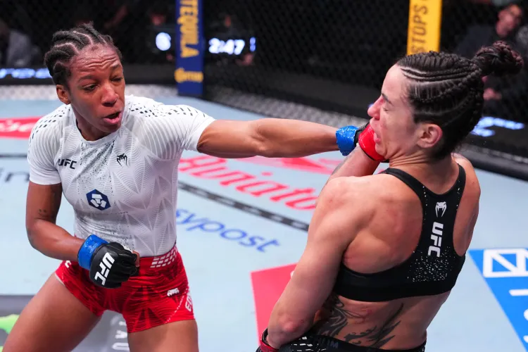 Two female UFC fighters exchange punches inside the octagon, a punch landing on the opponent's face.