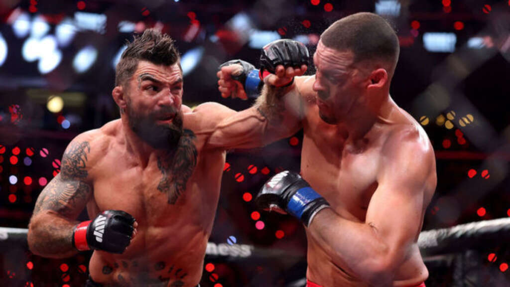 Nate-Diaz-and-Mike-Perry-exchange-during-MVP-MMA-1-fight - AfroCombat Two mixed martial artists exchange punches inside a cage during a fight.