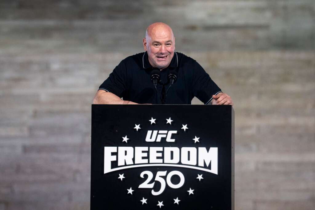 GettyImages-2280623395-1536x1024 - AfroCombat Man giving a speech at a podium with a UFC Freedom 250 logo in front of him.