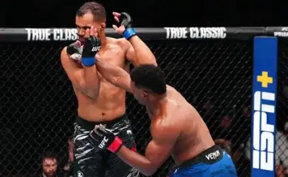 Two UFC fighters collide in the cage, one delivering a punch while the other braces for impact.