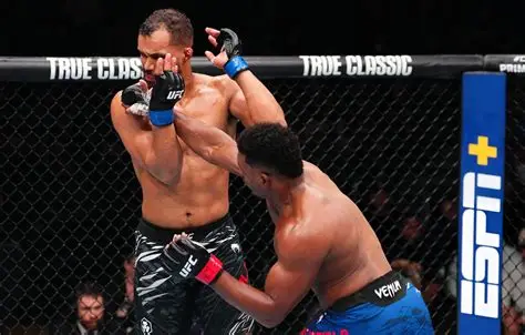 Two UFC fighters collide in the cage, one delivering a punch while the other braces for impact.