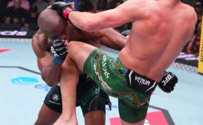 Two UFC fighters collide in the octagon as one delivers a high kick to the other’s head.