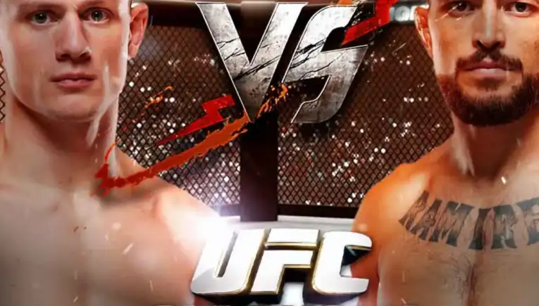 Two shirtless male MMA fighters face off inside a fenced octagon with 'UFC OKLAHOMA CITY' text.