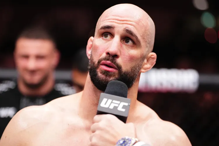 gettyimages-2247966997 - AfroCombat Bald, bearded male MMA fighter speaks into a UFC microphone during a post-fight interview.