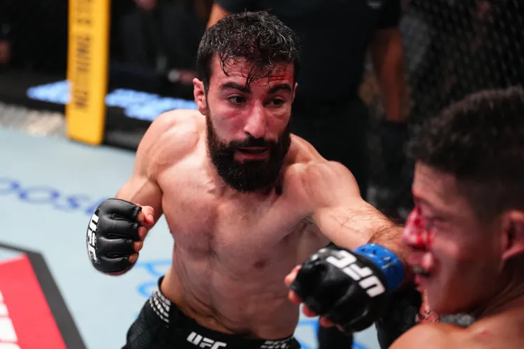 Bearded MMA fighter with black gloves delivering a punch during a UFC bout inside the octagon.