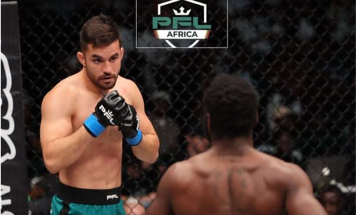 Two mixed martial artists in a cage engage in a fight; one faces the camera with blue gloves ready, the other with his back to us; PFL Africa logo above.
