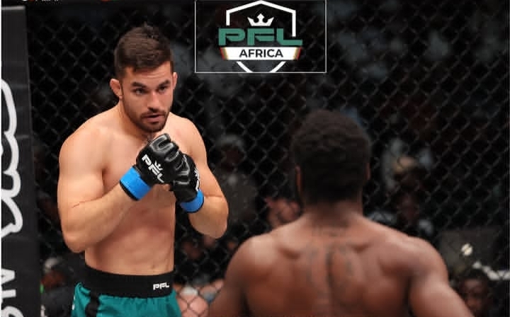 Two mixed martial artists in a cage engage in a fight; one faces the camera with blue gloves ready, the other with his back to us; PFL Africa logo above.