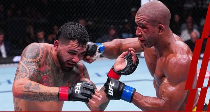 Two UFC fighters trade punches in a heated MMA bout inside the octagon, one landing a right hook while the other braces.
