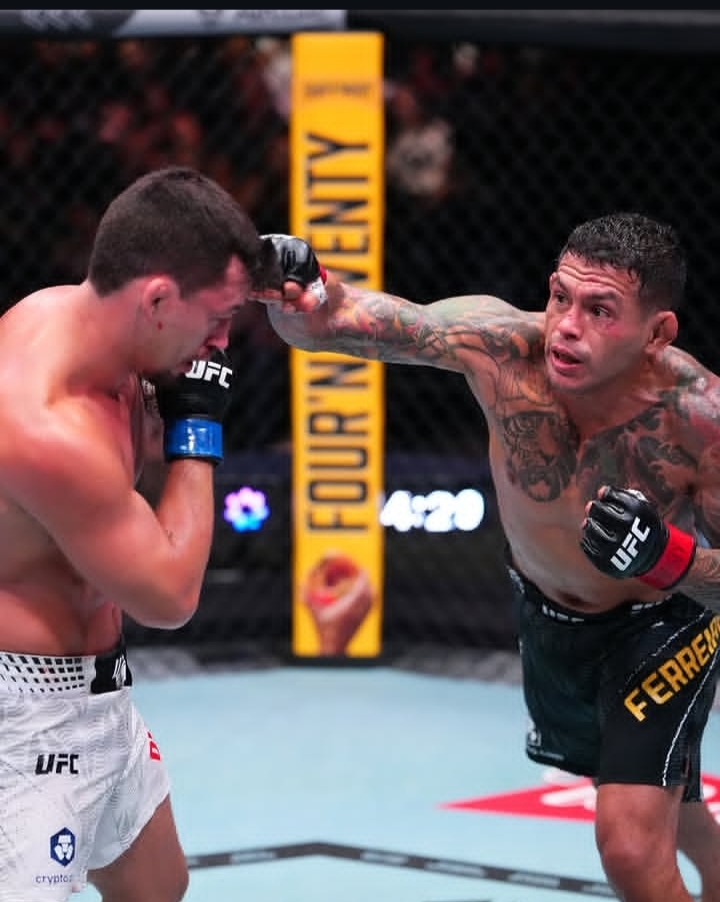 Two UFC fighters in the cage; one throws a punch toward the other who blocks with his guard.