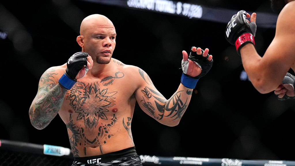b8e30d22463243fdb9ad6b71db6fb59f_xl - AfroCombat Tattooed, bald MMA fighter inside the UFC cage with gloved fists raised, ready for action.