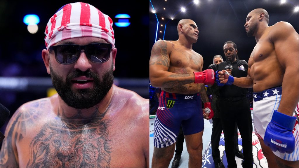 Bearded, shirtless man wearing a red-and-white striped bandana and dark sunglasses, showing a large chest tattoo in a dim arena setting.